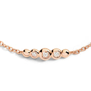 Gioiello bracciale Bollicine in oro rosa con diamanti, simbolo di eleganza e luminosità.